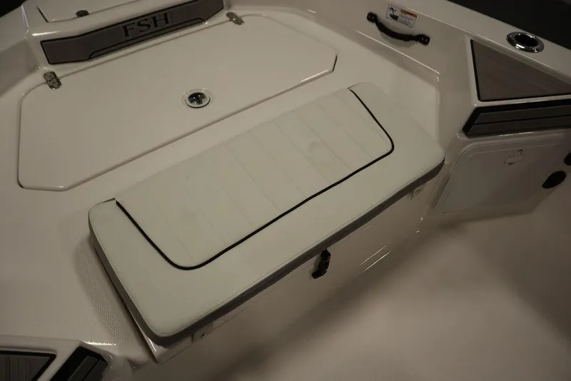Slide: The Image of 2025 Yamaha Boats 190 FSH Sport deck with cushioned seating and storage. - 14