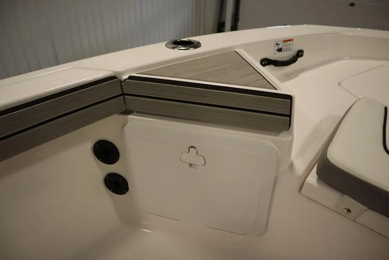 Slide: The Image of 2025 Yamaha Boats 190 FSH Sport interior detail, featuring sleek design and storage compartment. - 16