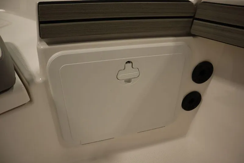 Slide: The Image of 2025 Yamaha Boats 190 FSH Sport interior compartment detail with sleek design. - 17