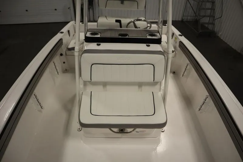 Slide: The Image of 2025 Yamaha Boats 190 FSH Sport interior with white seating and steering console. - 20