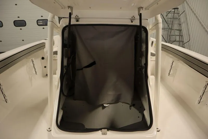 Slide: The Image of 2025 Yamaha Boats 190 FSH Sport storage compartment with open hatch. - 21