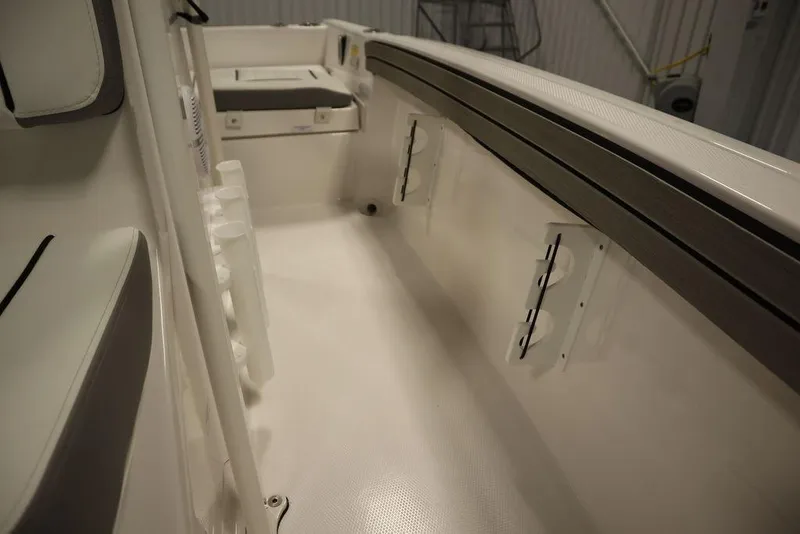 Slide: The Image of 2025 Yamaha Boats 190 FSH Sport interior, featuring spacious seating and sleek design. - 24