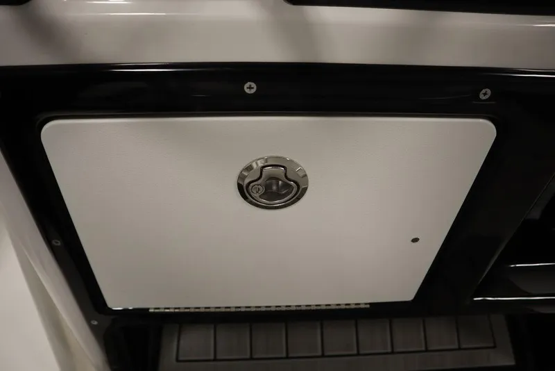 Slide: The Image of 2025 Yamaha Boats 190 FSH Sport storage compartment with secure latch. - 29
