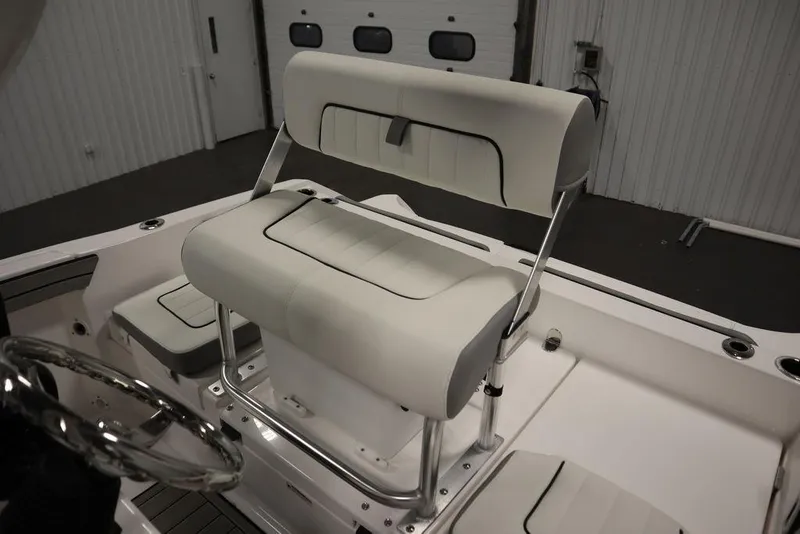 Slide: The Image of 2025 Yamaha Boats 190 FSH Sport interior with white seating and steering wheel. - 32