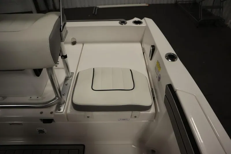 Slide: The Image of 2025 Yamaha Boats 190 FSH Sport interior seating detail, white upholstery, sleek design. - 33