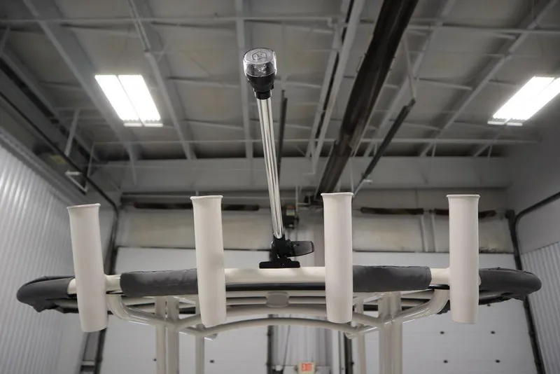 Slide: The Image of 2025 Yamaha Boats 190 FSH Sport fishing rod holders and light in a garage. - 39