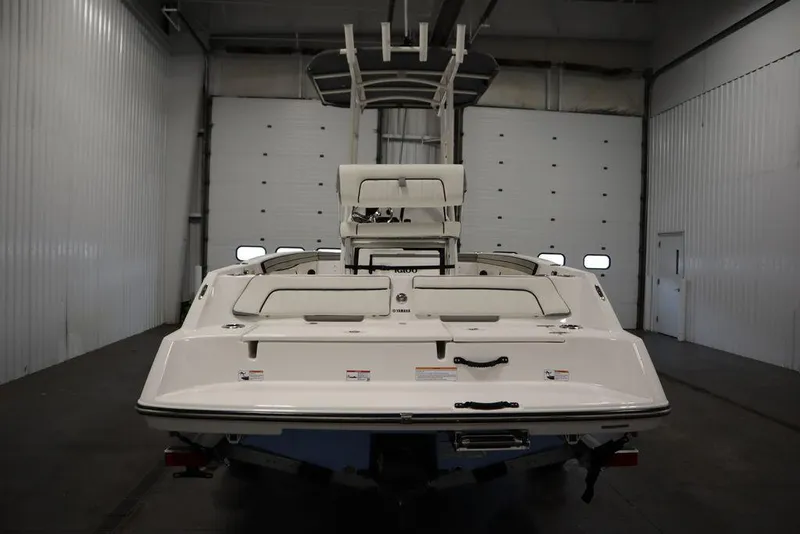 Slide: The Image of 2025 Yamaha Boats 190 FSH Sport in a warehouse, rear view. - 4