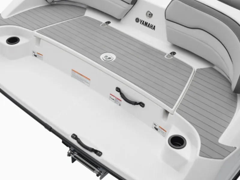 Slide: The Image of 2025 Yamaha Boats 190 SX swim platform with gray decking and cup holders. - 2