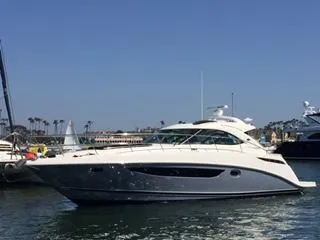 Slide: The Image of 2015 Sea Ray 410 Sundancer yacht cruising in a sunny marina. - 0