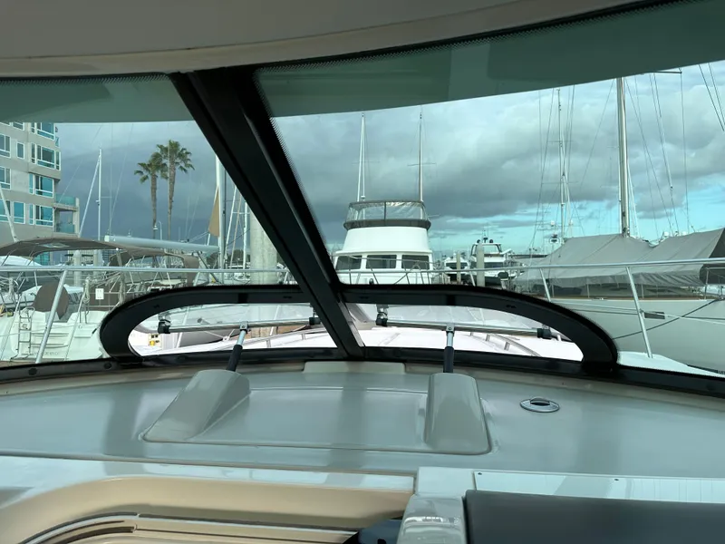 Slide: The Image of View from 2015 Sea Ray 410 Sundancer yacht cockpit, overlooking marina with cloudy sky. - 11