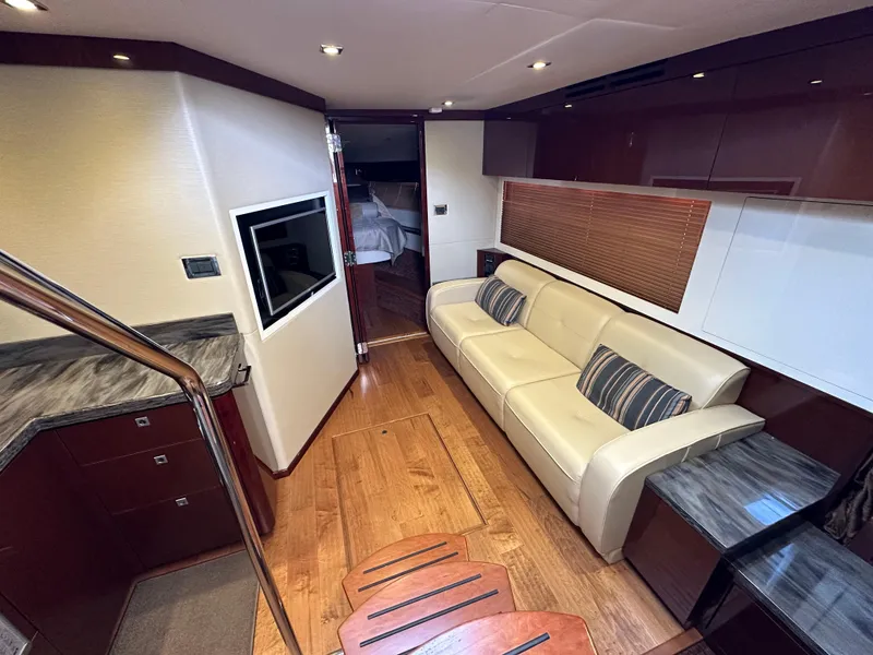 Slide: The Image of Luxurious interior of 2015 Sea Ray 410 Sundancer yacht with sofa and TV. - 12