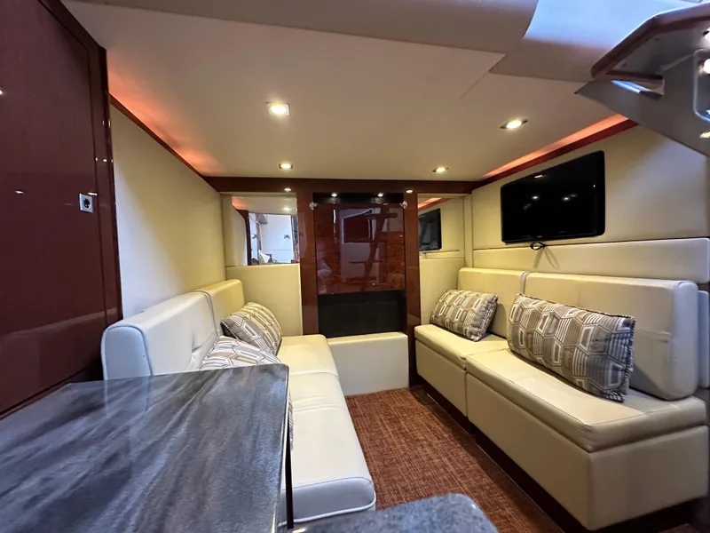 Slide: The Image of Luxurious interior of 2015 Sea Ray 410 Sundancer yacht with plush seating and modern decor. - 14