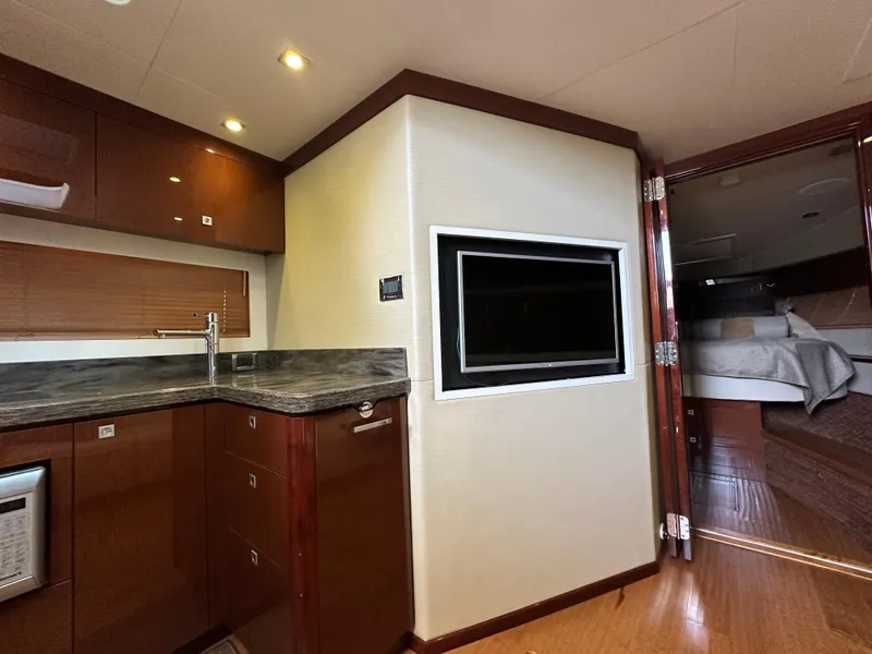 Slide: The Image of Luxurious interior of 2015 Sea Ray 410 Sundancer yacht with modern kitchen and cozy bedroom. - 15