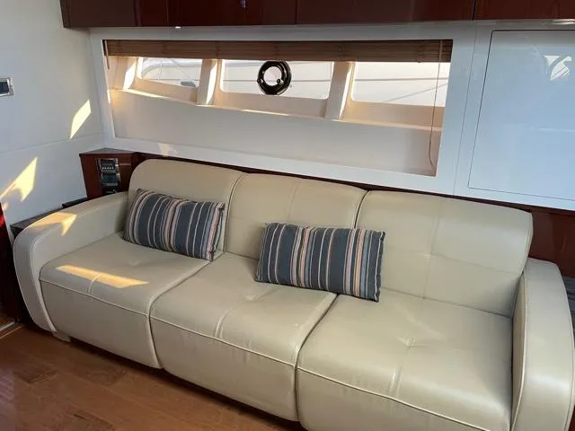 Slide: The Image of Luxurious interior of 2015 Sea Ray 410 Sundancer yacht with beige leather sofa and striped cushions. - 16