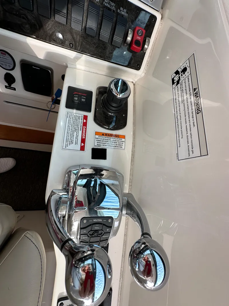 Slide: The Image of Control panel of 2015 Sea Ray 410 Sundancer boat with throttle and switches. - 18