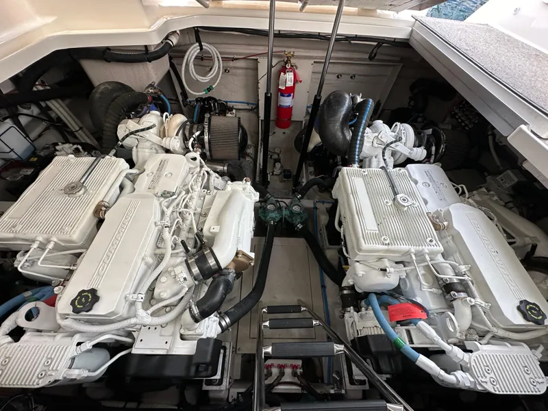 Slide: The Image of Engine room of 2015 Sea Ray 410 Sundancer with dual engines and fire extinguisher. - 19