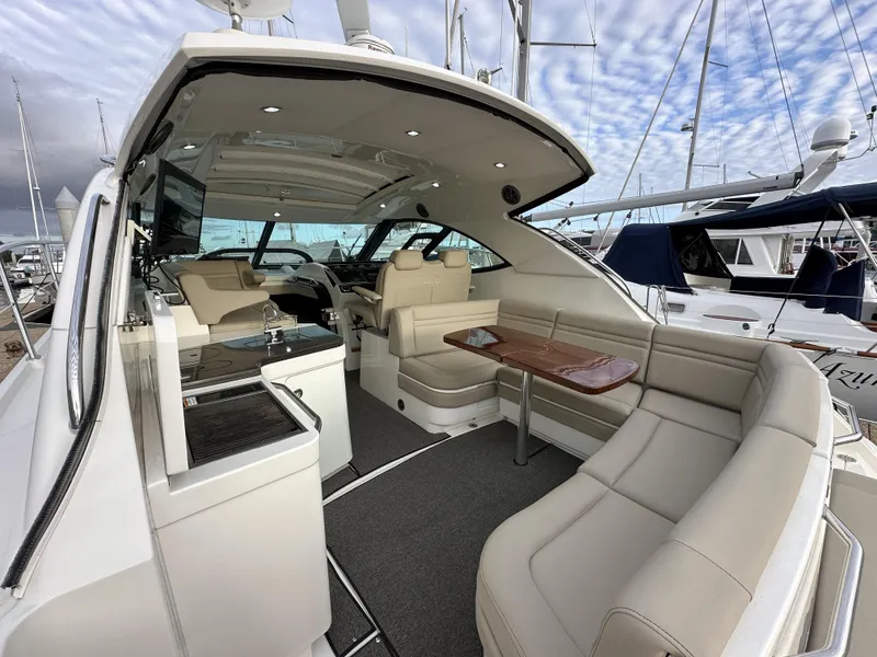Slide: The Image of 2015 Sea Ray 410 Sundancer yacht interior with plush seating and elegant design. - 2