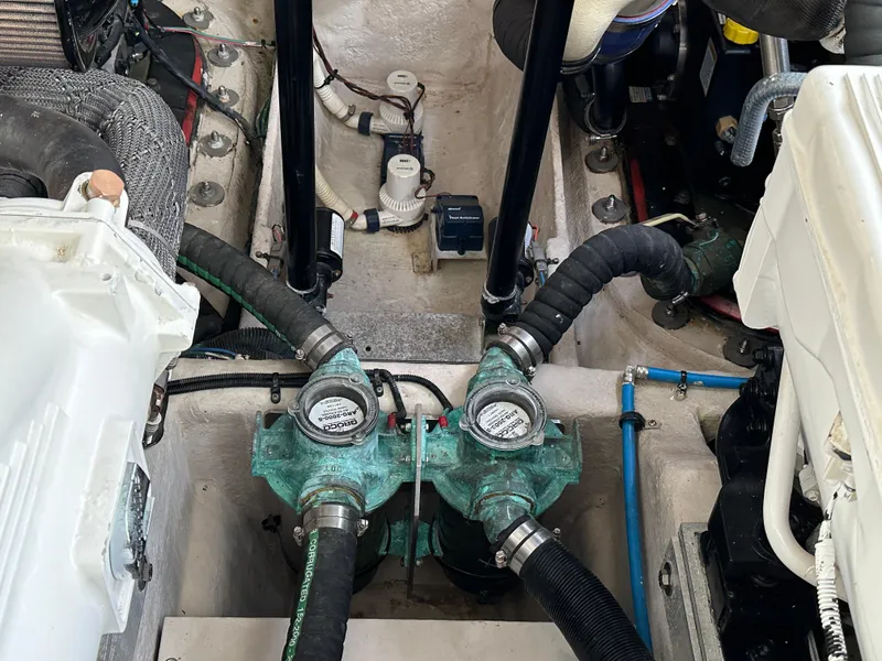 Slide: The Image of Engine compartment of 2015 Sea Ray 410 Sundancer with visible hoses and components. - 21