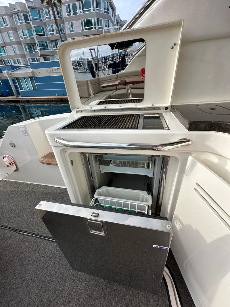 Slide: The Image of 2015 Sea Ray 410 Sundancer yacht with outdoor kitchenette and mini fridge. - 6