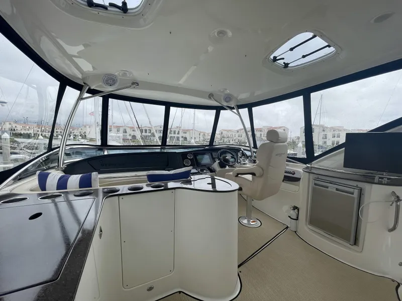 Slide: The Image of Interior of 2011 Meridian 441 Sedan Bridge yacht, featuring helm and seating area. - 17
