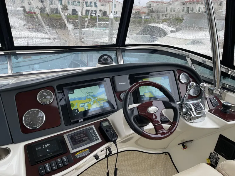 Slide: The Image of 2011 Meridian 441 Sedan Bridge helm with navigation screens and controls. - 20
