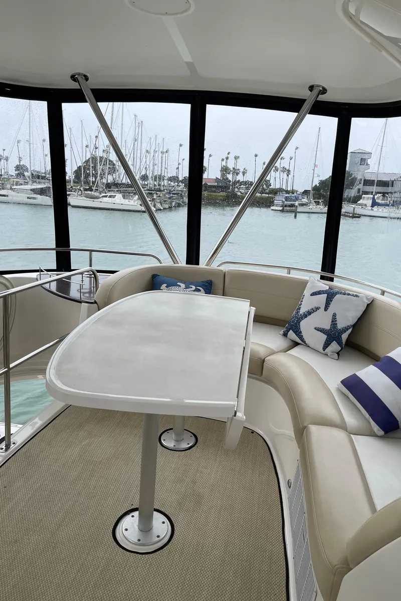 Slide: The Image of 2011 Meridian 441 Sedan Bridge interior with seating and table, overlooking marina. - 22