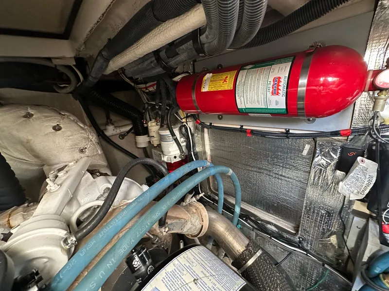 Slide: The Image of Engine room of 2011 Meridian 441 Sedan Bridge, featuring fire extinguisher and various components. - 31