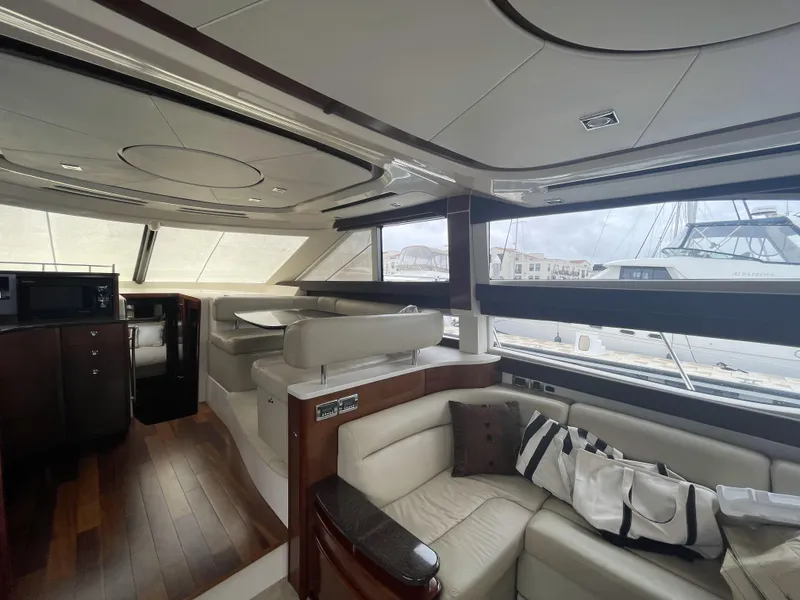 Slide: The Image of Luxurious interior of 2011 Meridian 441 Sedan Bridge yacht with elegant seating and wood flooring. - 5