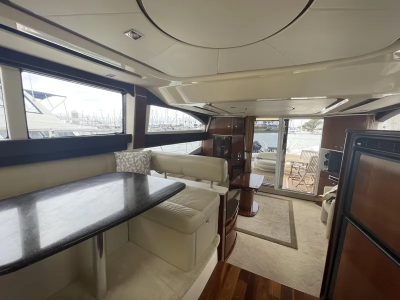 Slide: The Image of Luxurious interior of 2011 Meridian 441 Sedan Bridge yacht with elegant seating and dining area. - 7