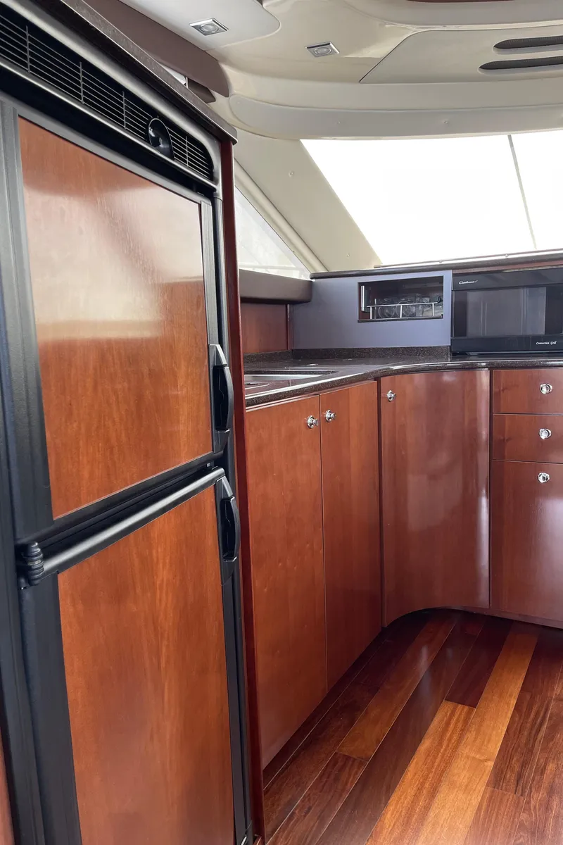 Slide: The Image of Luxurious 2011 Meridian 441 Sedan Bridge yacht interior with sleek wood cabinetry. - 8