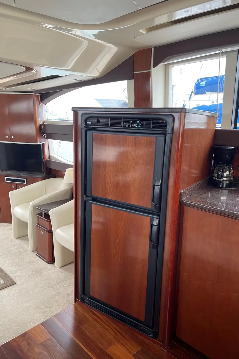 Slide: The Image of Luxurious interior of 2011 Meridian 441 Sedan Bridge yacht with wood finishes and modern amenities. - 9