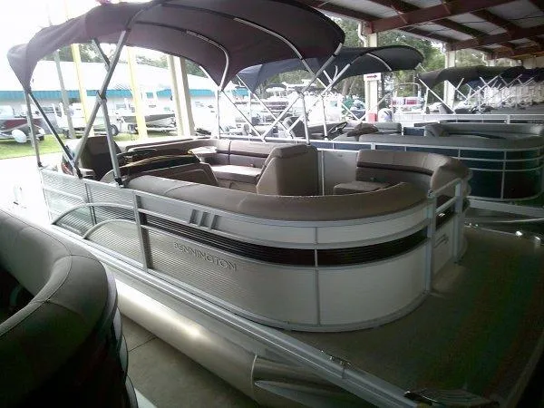 Slide: The Image of 2024 Bennington 20SLX pontoon boat with canopy in showroom. - 10