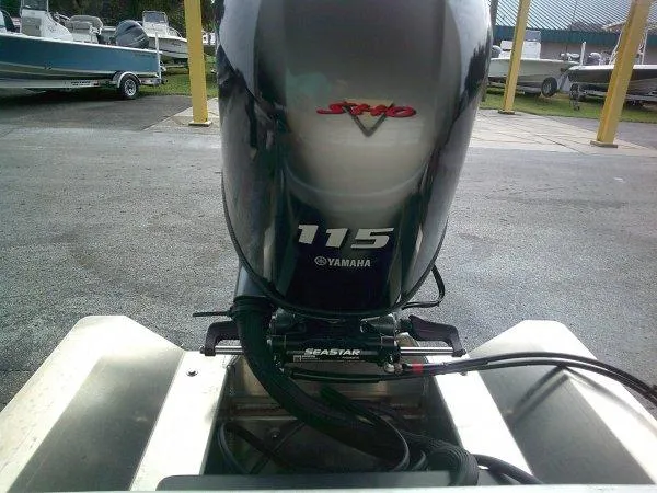 Slide: The Image of 2024 Bennington 20SLX with Yamaha 115 outboard motor in a marina setting. - 5