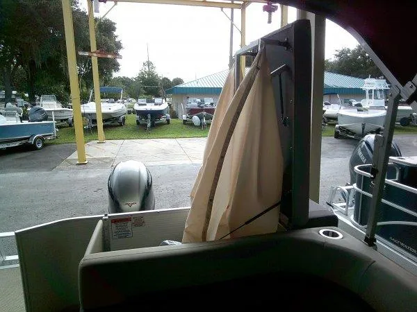 Slide: The Image of 2024 Bennington 20SLX pontoon boat interior with view of marina. - 6