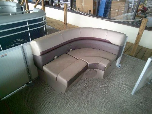 Slide: The Image of 2024 Bennington 20SLX pontoon boat seating, beige and brown upholstery, showroom display. - 8