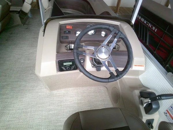 Slide: The Image of 2024 Bennington 20SLX boat dashboard with steering wheel and controls. - 9