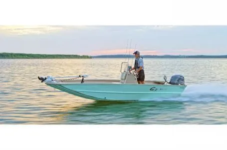 Slide: The Image of 2021 G3 Bay 17 boat cruising on a serene lake at sunset. - 13