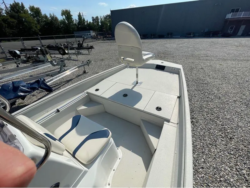 Slide: The Image of 2021 G3 Bay 17 boat with seating, parked on gravel lot. - 17