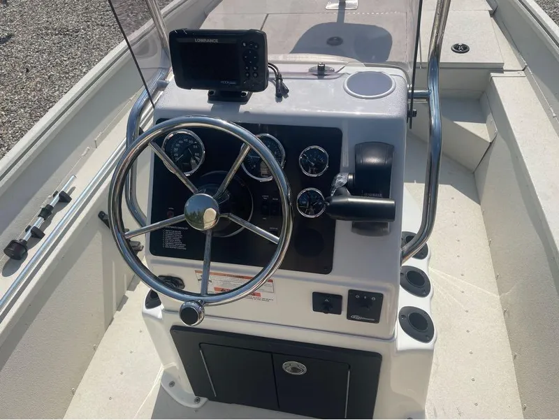 Slide: The Image of 2021 G3 Bay 17 boat console with steering wheel and navigation equipment. - 18