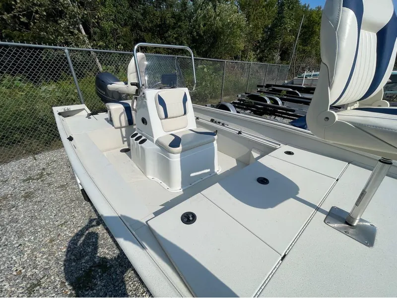 Slide: The Image of 2021 G3 Bay 17 boat with white seating and console, parked on gravel. - 19
