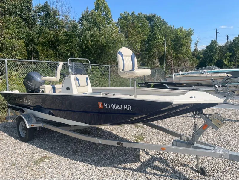 Slide: The Image of 2021 G3 Bay 17 boat on trailer, parked outdoors, with Yamaha motor. - 4