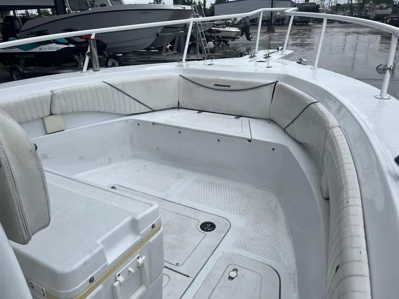 Slide: The Image of 2008 Triumph 215 CC boat interior with white seating and storage compartments. - 11