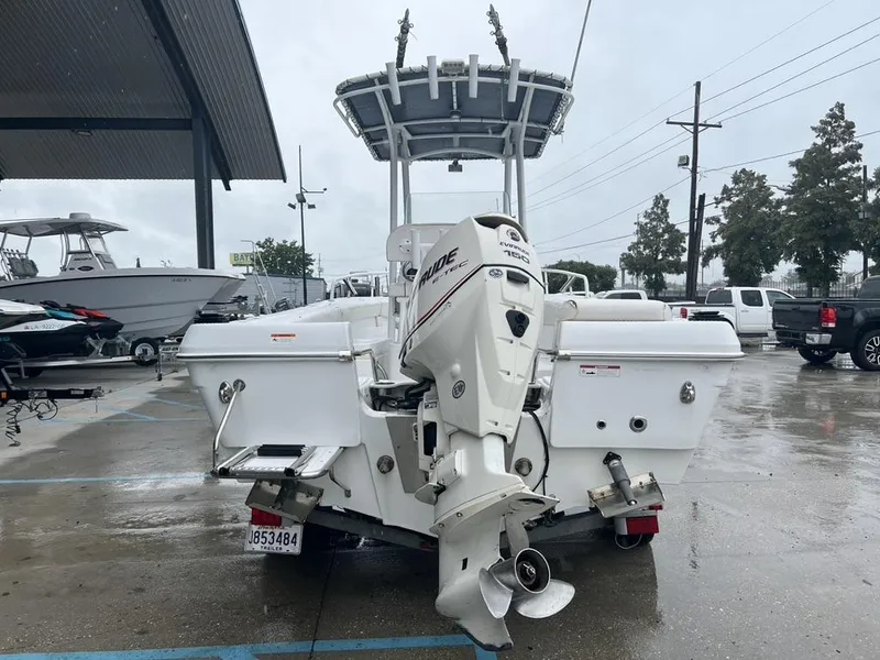 Slide: The Image of 2008 Triumph 215 CC boat with Evinrude engine in a parking lot. - 12