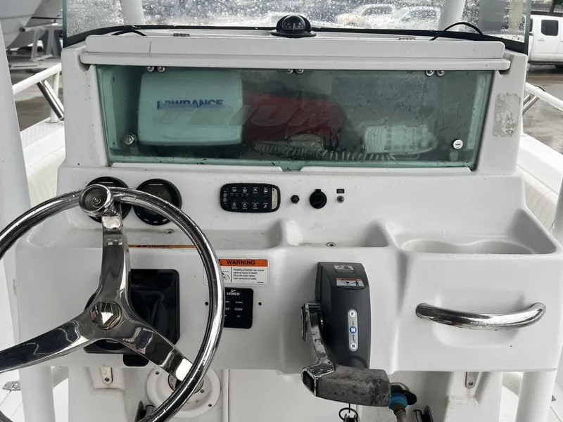 Slide: The Image of 2008 Triumph 215 CC boat dashboard with steering wheel and controls. - 13