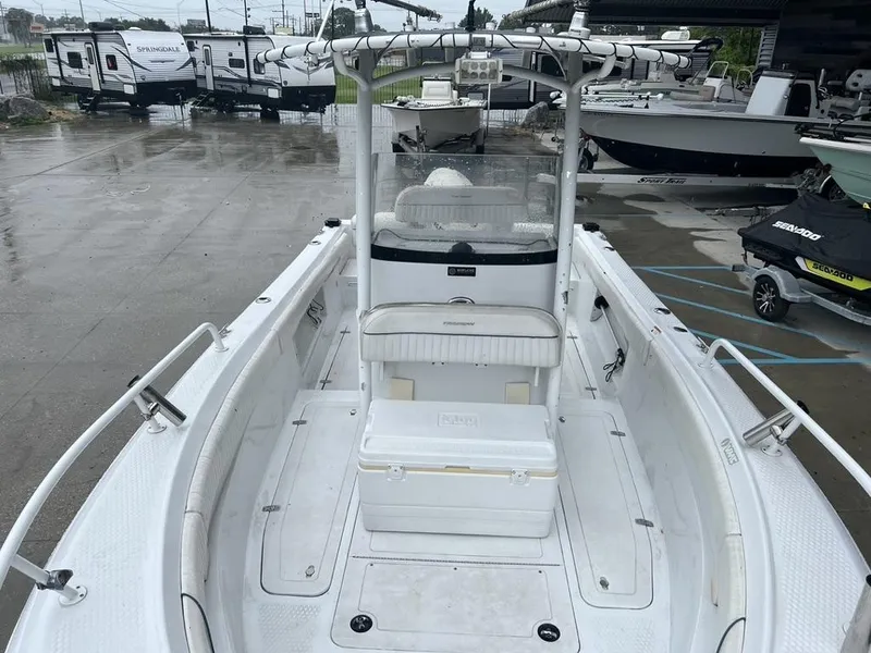 Slide: The Image of 2008 Triumph 215 CC boat with center console, parked near RVs and jet skis. - 3