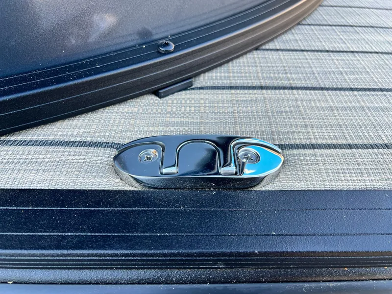 Slide: The Image of Close-up of a 2025 Sylvan L1 DLZ boat cleat on textured deck. - 12