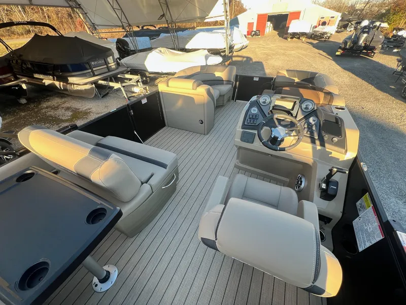 Slide: The Image of 2025 Sylvan L1 DLZ pontoon boat interior with beige seating and steering console. - 15