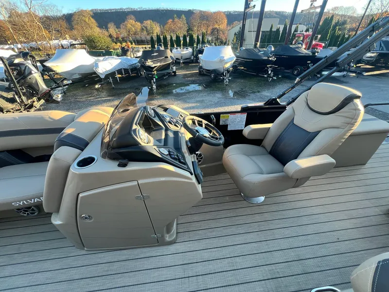 Slide: The Image of 2025 Sylvan L1 DLZ boat interior with steering console and captain's chair. - 24