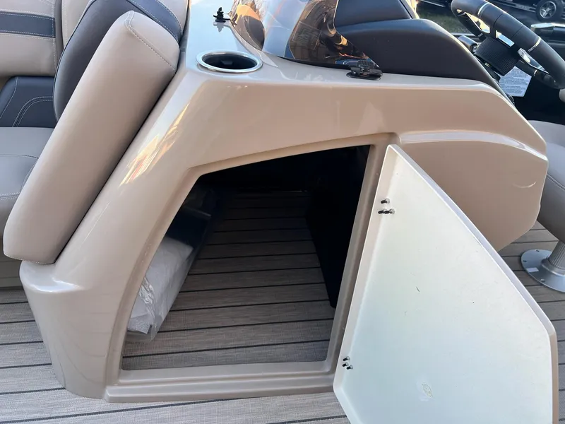 Slide: The Image of 2025 Sylvan L1 DLZ boat storage compartment with open door on deck. - 25