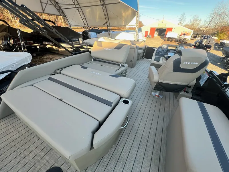 Slide: The Image of 2025 Sylvan L1 DLZ pontoon boat interior with plush seating and modern dashboard. - 26